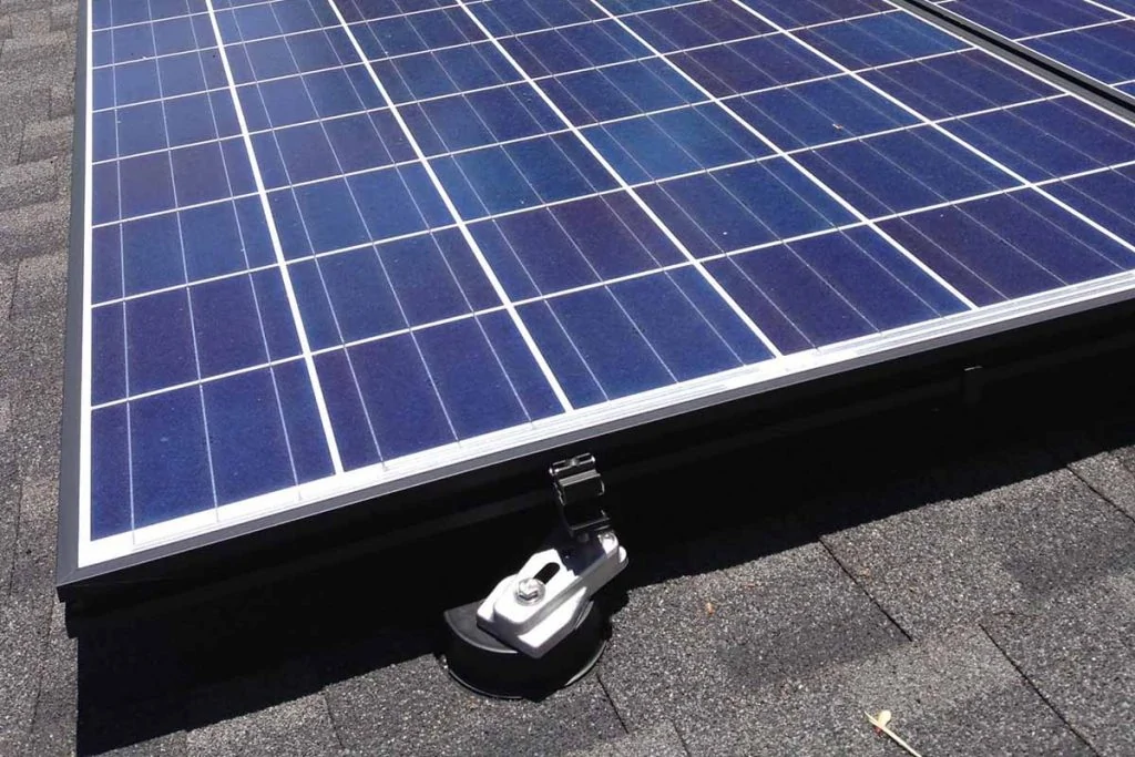 a metal fixture holding a solar panel on the roof