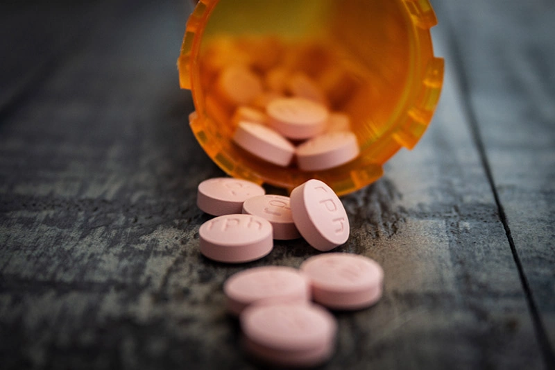 a bottle with pink pills