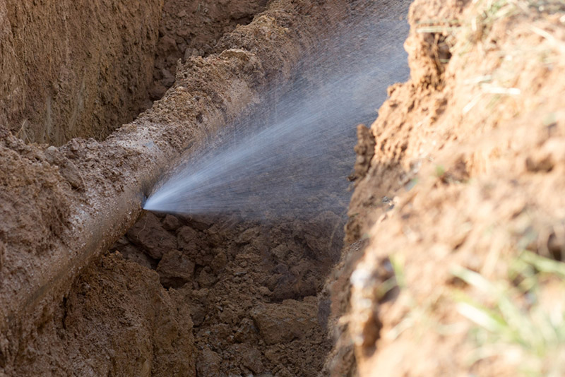 water leaking through a broken water pipe