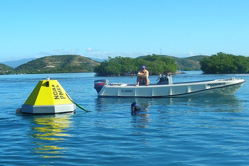 a yellow buoy in the ocean used for measuring CO2 levels