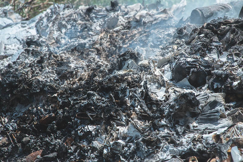 a pile of ash from a burned solid waste