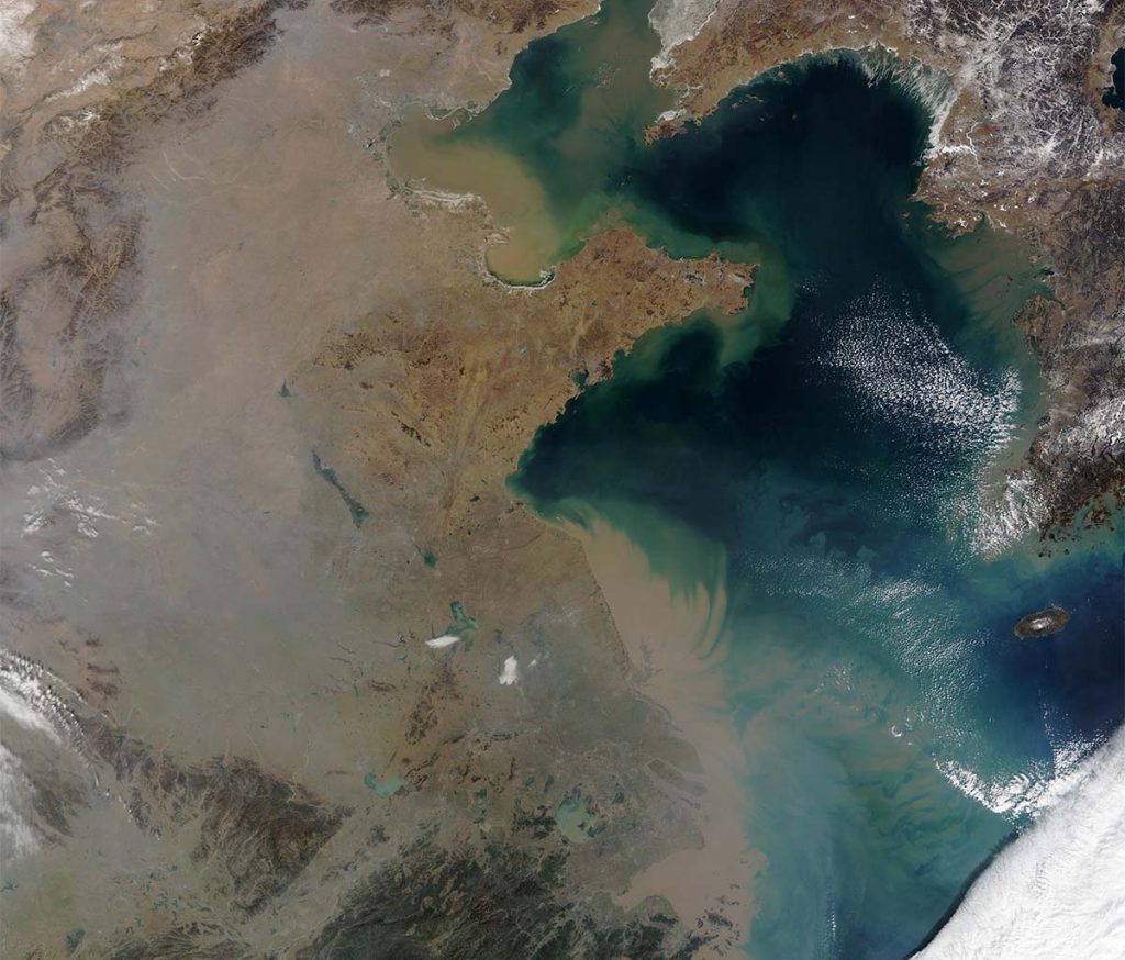 a satellite shot of a brown cloud over China