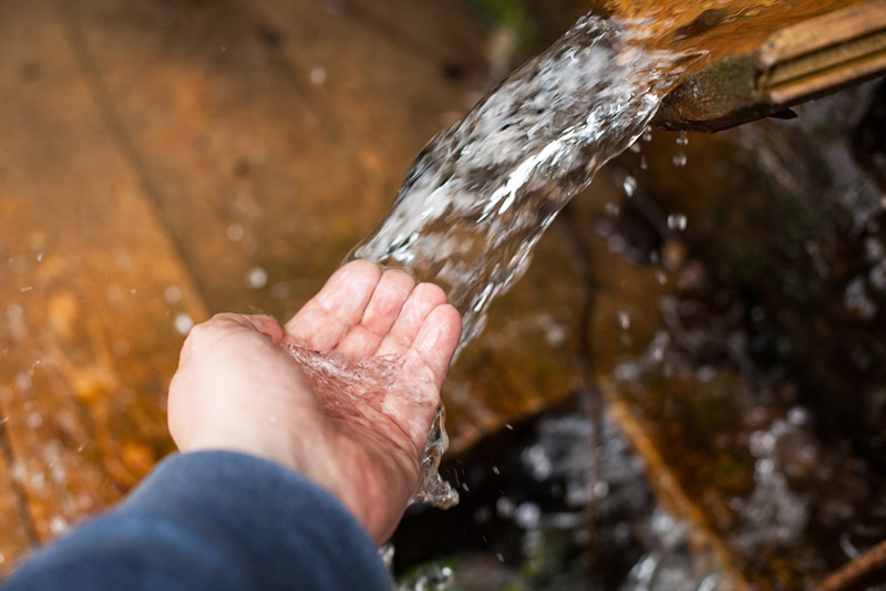 clean water flows into a man's hand