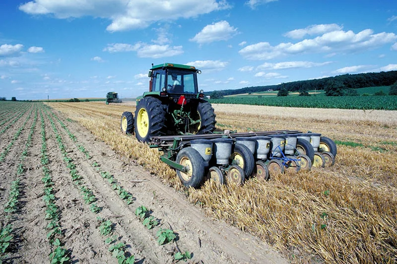 a tractor performing conservation tillage on an agricultural field