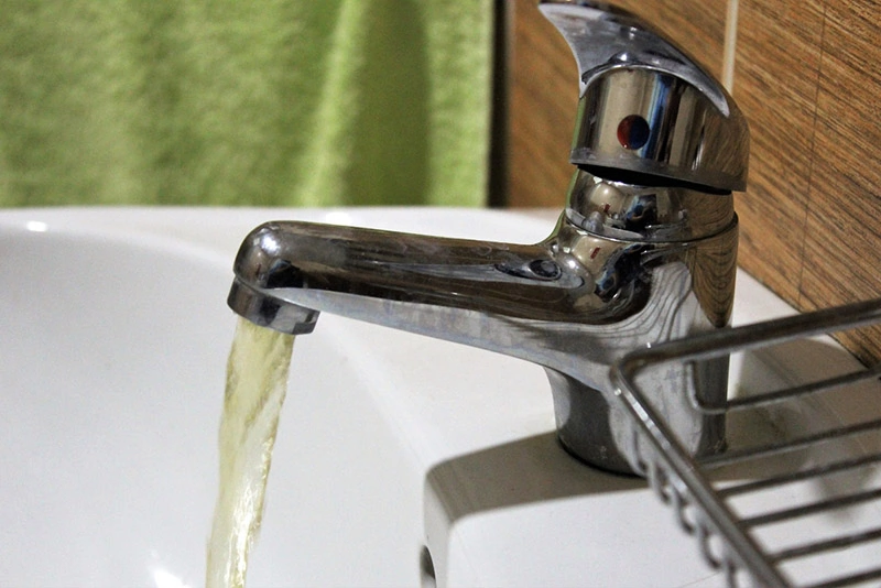 dirty water water running from a faucet in the bathroom