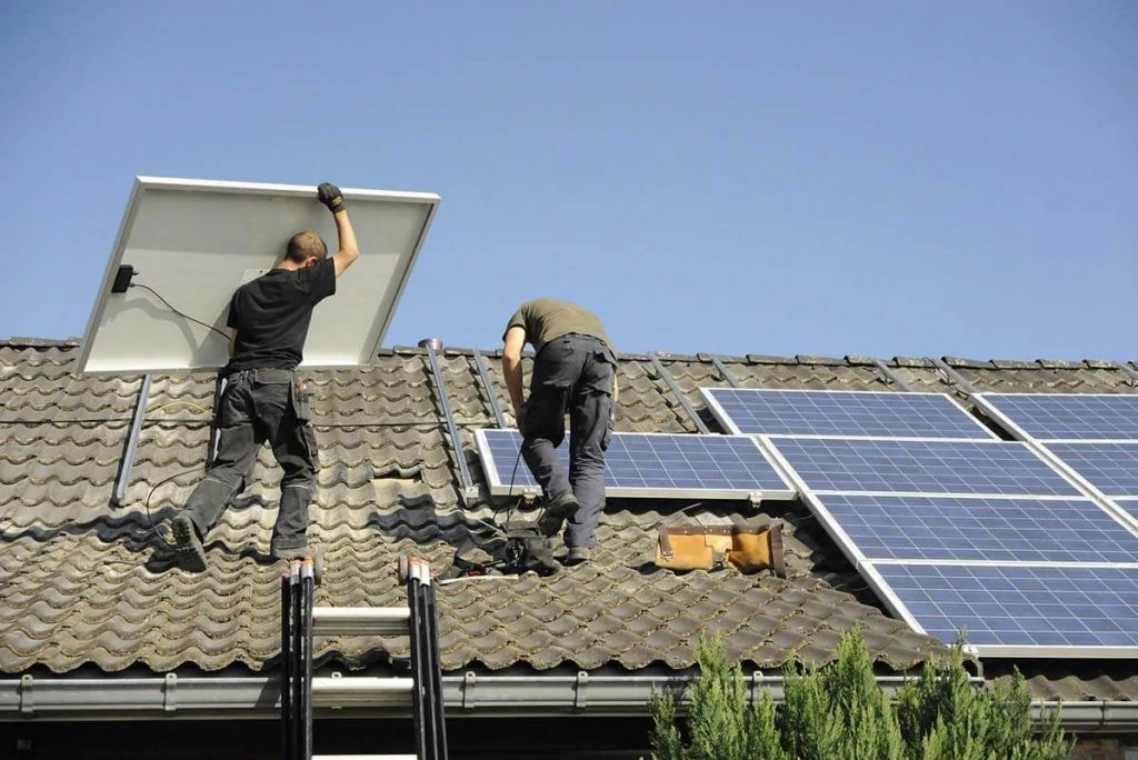 Two man on the roof installing solar panels