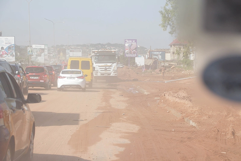 a busy road with erosion pollution in the air