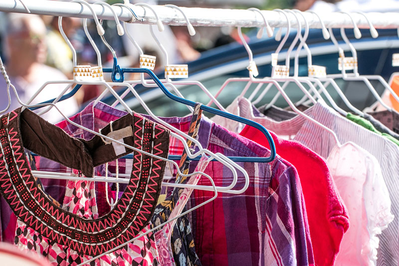 fast fashion clothing items on hangers