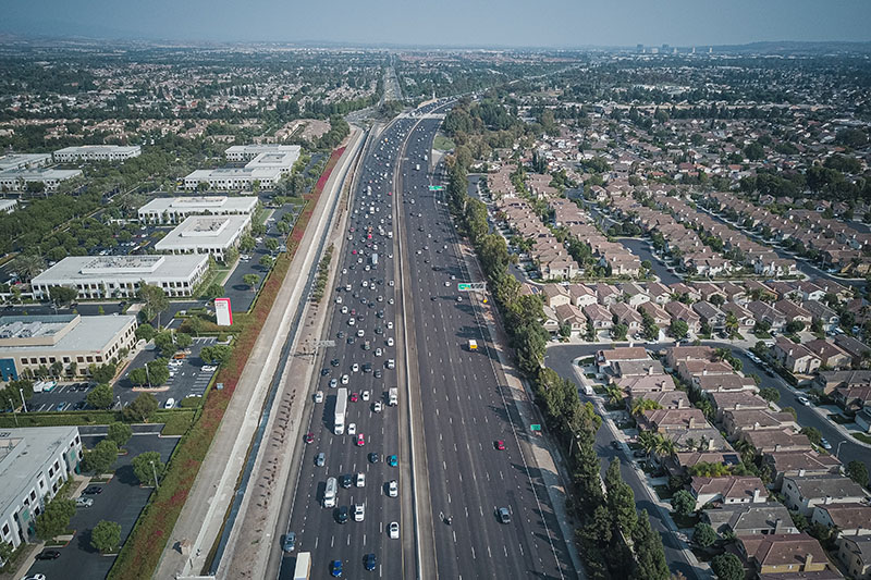 an aerial view of the freeway near residential area