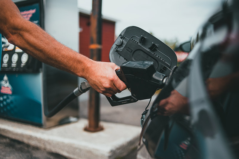 a person pumping gas into a car