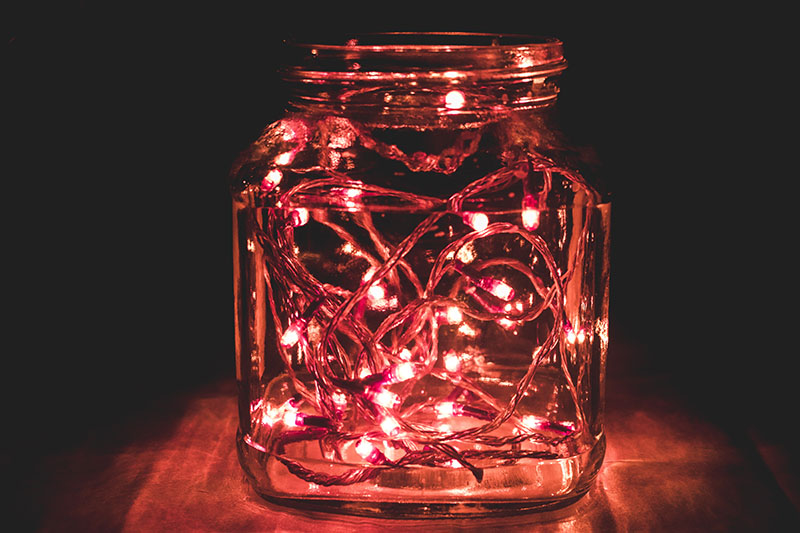 red string lights inside a glass jar