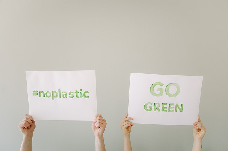 no plastic and go green signs on white paper