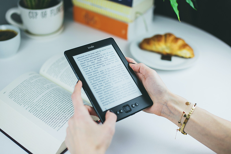 a woman holding kindle ereader