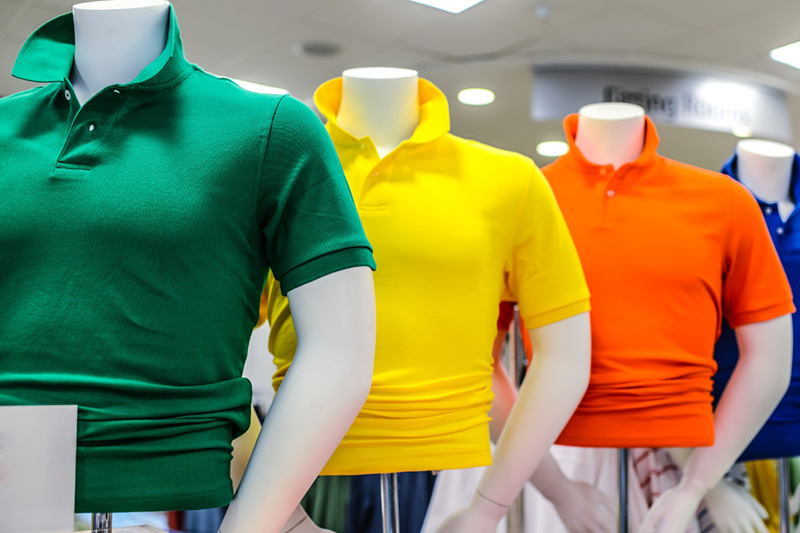men's polos on mannequins in a fast fashion clothing store 