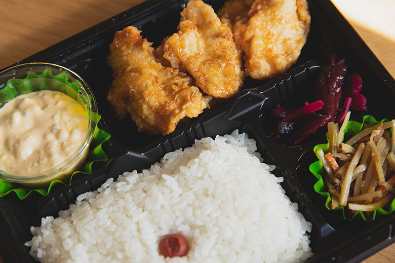 rice and fried chicken in a microwave meal container