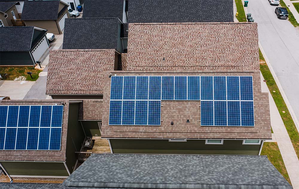 multiple solar panels on the roof of a residential building
