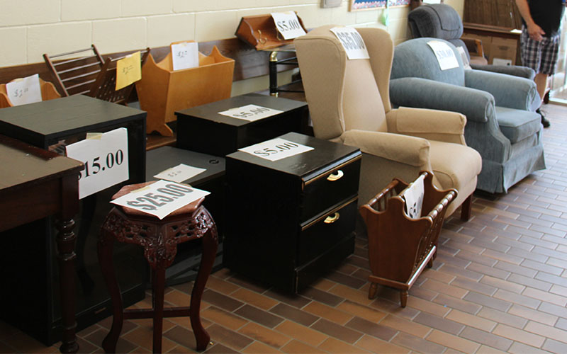 old furniture pieces with price tags on garage sale
