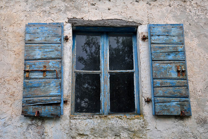 old house windows with chipped paint