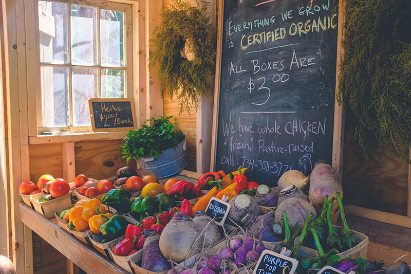 a small shop with organic vegetables on display