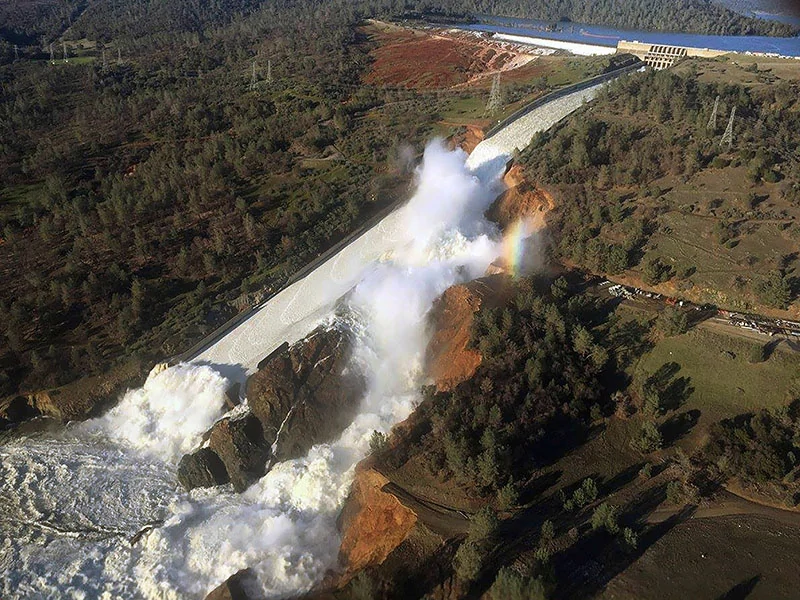 Water flowing from the eroded overflow spillway of Oroville Dam, CA