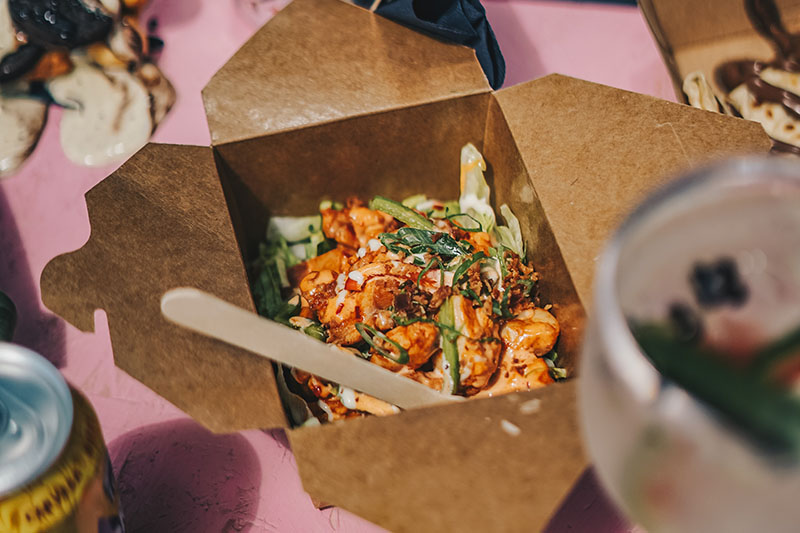 PE-coated paper container with cooked food inside
