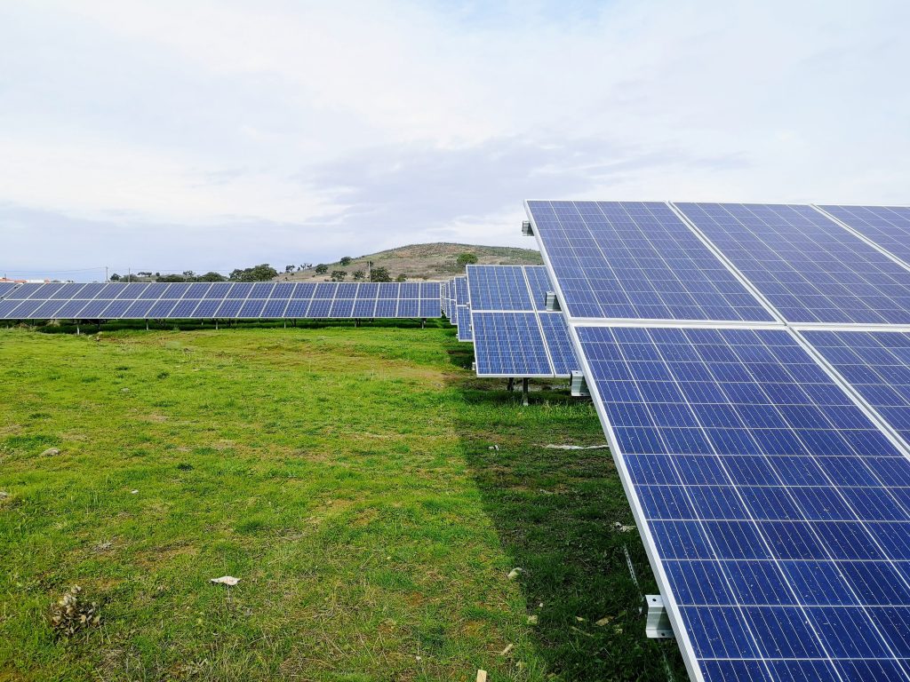 solar panels in a field | pros and cons of photovoltaic cells