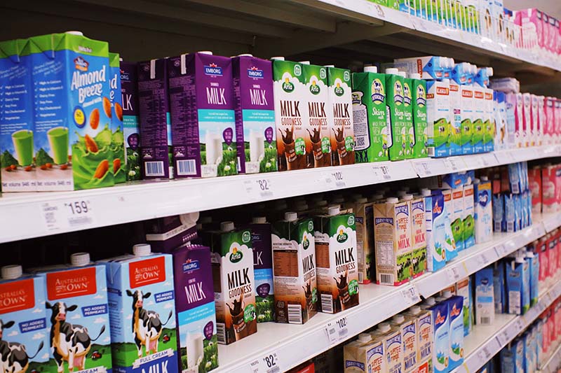 store shelves with various milk cartons
