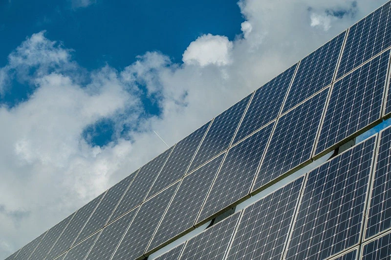 solar panels under a cloudy sky