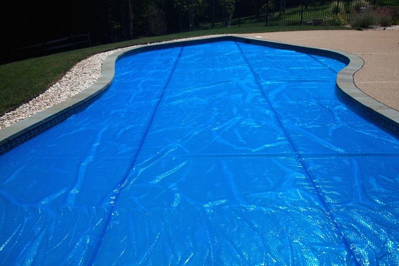 outdoor pool covered with solar blanket