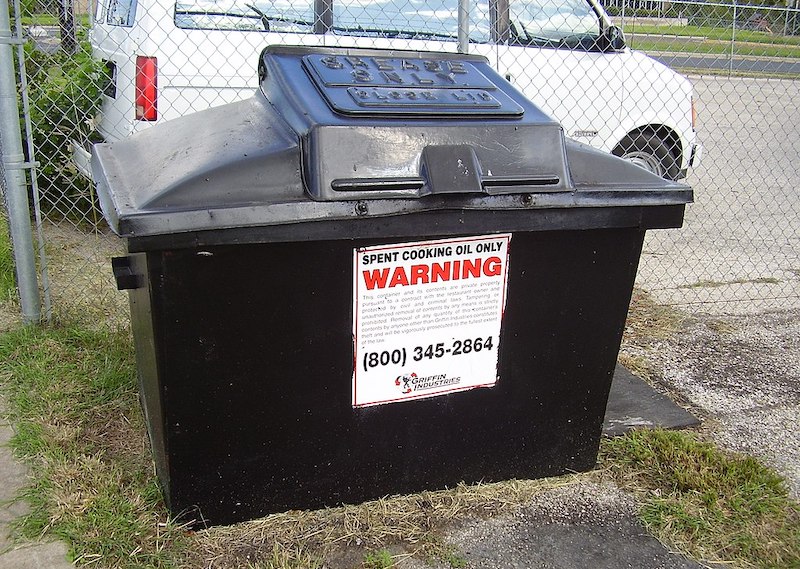 a black bin for spent cooking oil