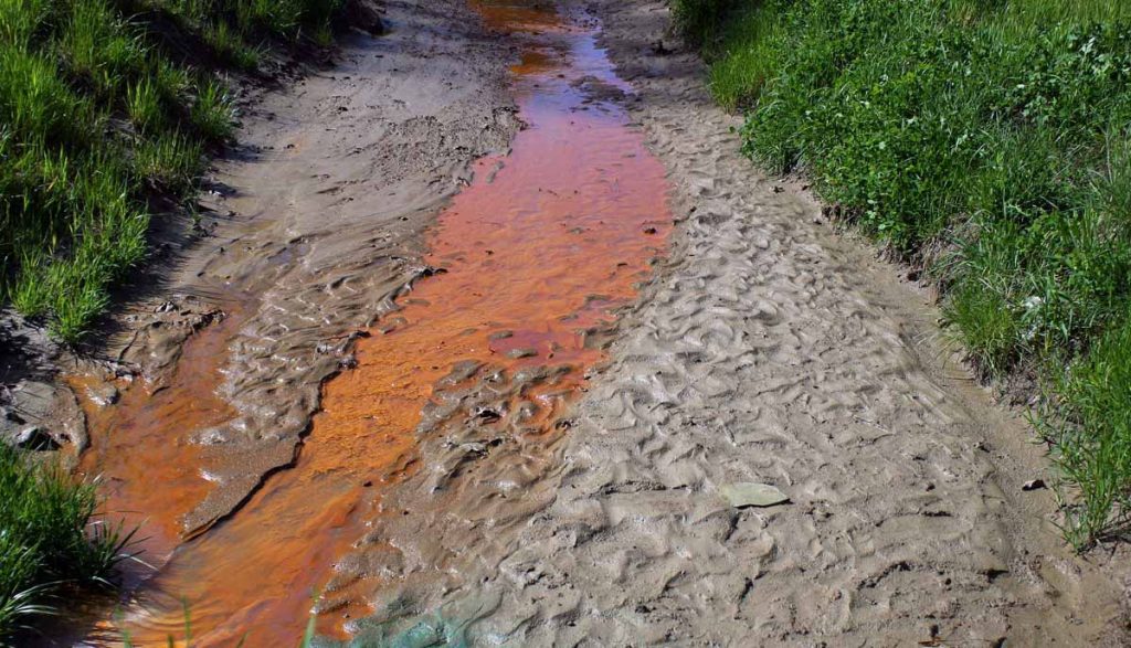 a stream with orange color water