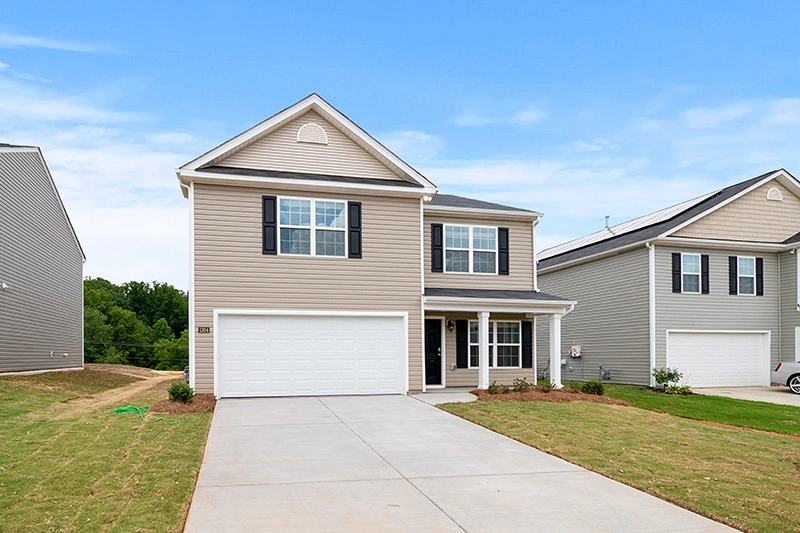 a white and grey house under a blue sky
