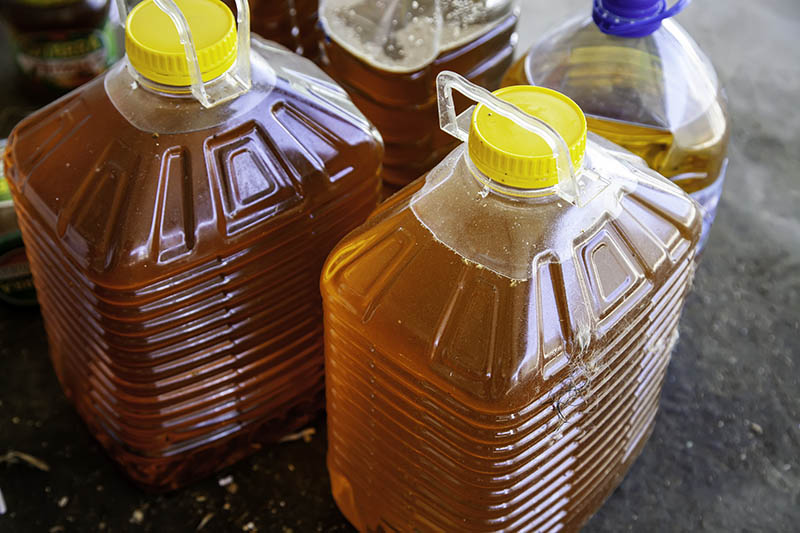 used cooking oil in big plastic bottles
