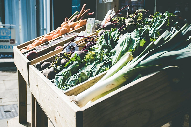 leaf vegetables on brown wooden stand